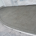 Stamp concrete patio with monolithic curb