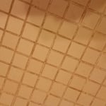 Before color seal. Blotchy and discolored grout.