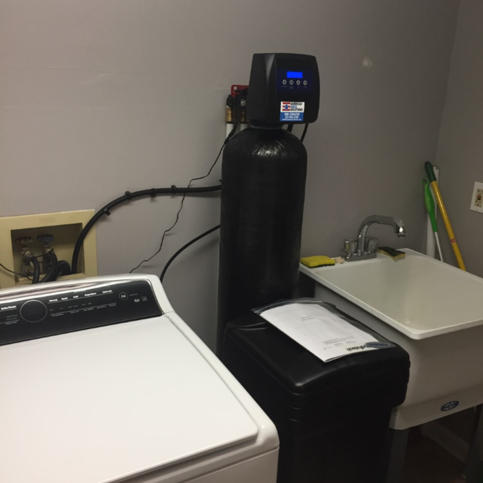 metered water softener plumbed through wall