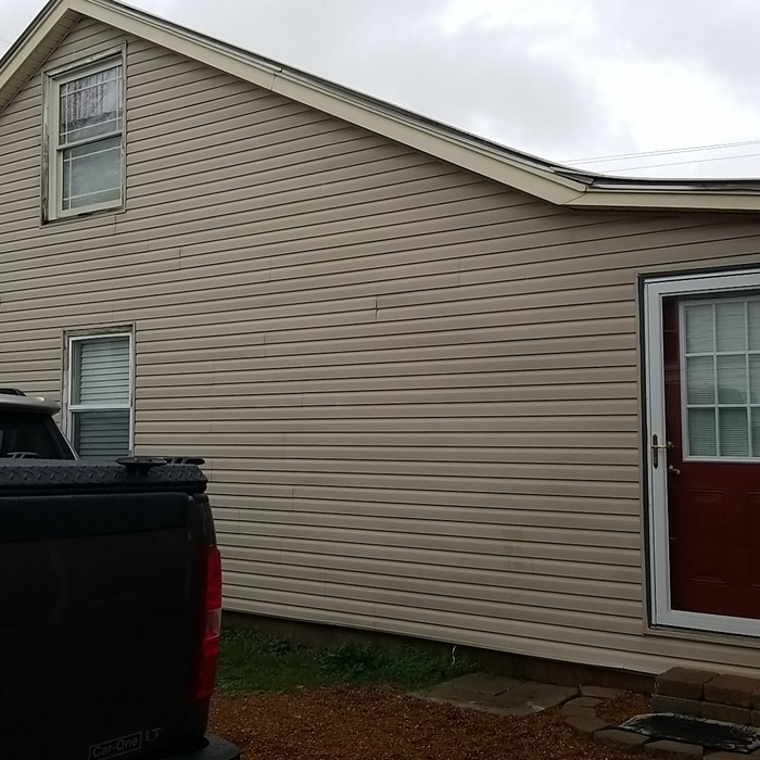 SIde view of old vinyl siding and old windows