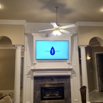Tv above fireplace