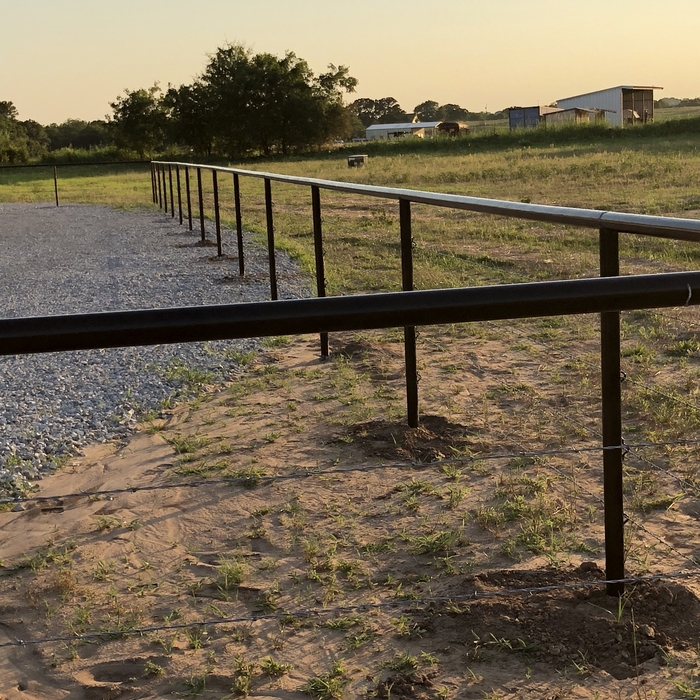 Perimeter barbed wire and top rail.