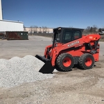 Skidloader installing rock at work site
