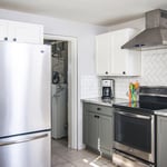 Tiled backsplash and installed hood vent