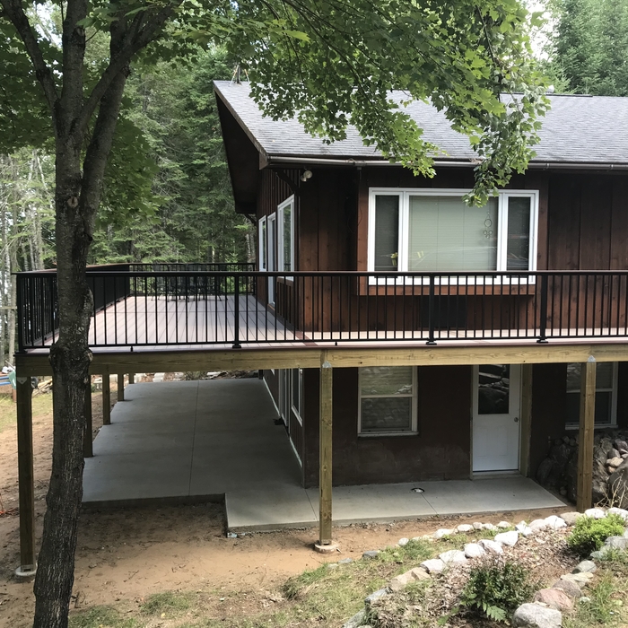 Completed deck being viewed from side of home.