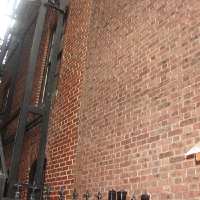 Side of building; rebuilt fire escape structure