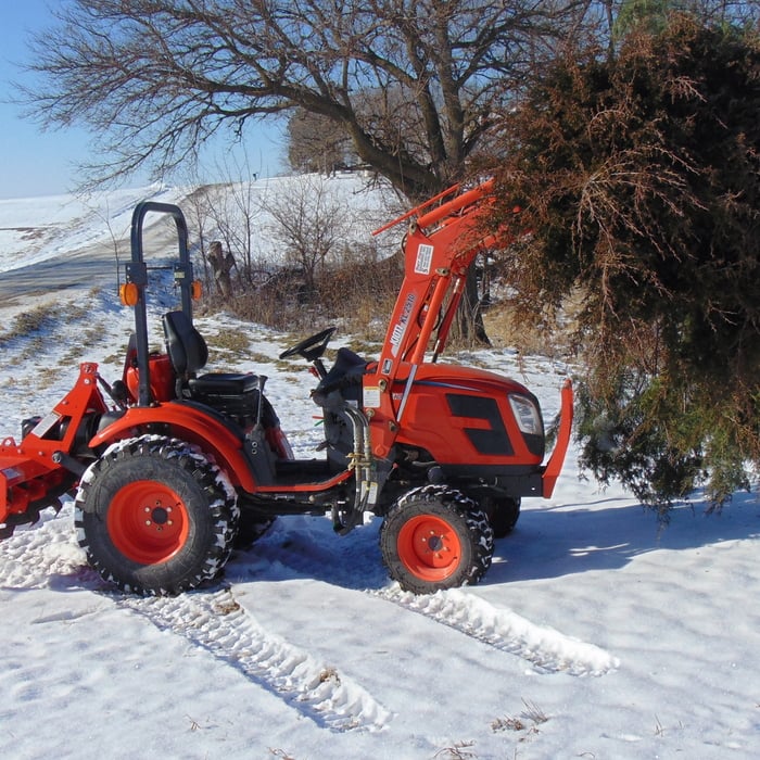 tractor and tiller caring a tree