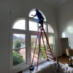 Chad Westberry installing film on arch window