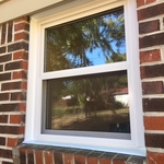 New window with custom exterior trim in brick