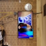 55' tv hung on a brick wall.