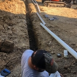 running downspouts to drain pipe and out to woods
