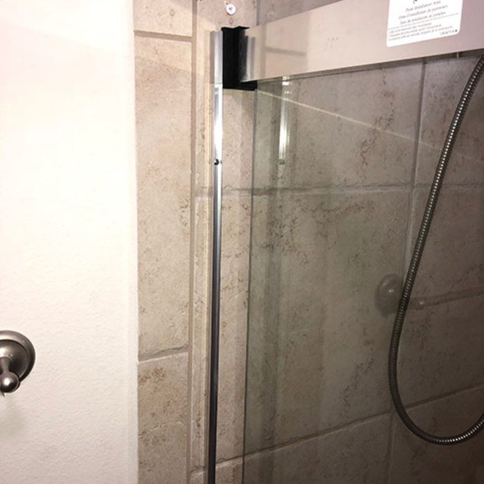 caluking-and-sealing-edges-of-a-custom-shower-door