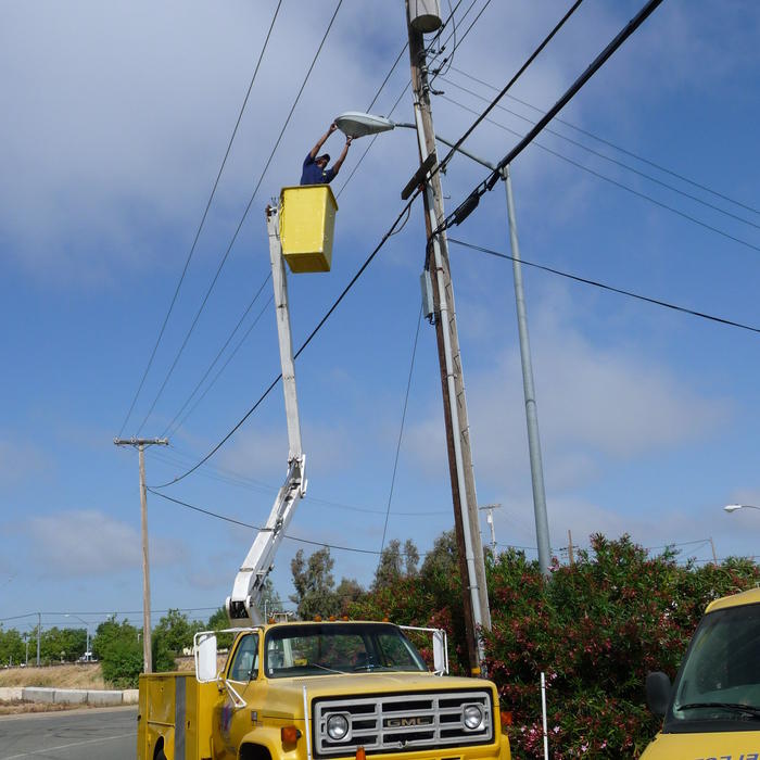 Installing street light in bucket truck