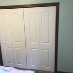 Bedroom closet bifold doors and casing.