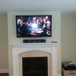 TV over fireplace with a speaker bar