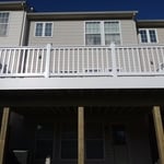 Second story composite deck w/ vinyl railing.