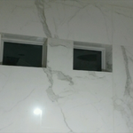 Port windows wrapped with large format porcelain t