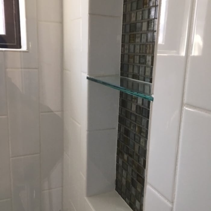 Glass shelf embedded into shower niche