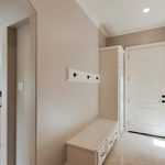 Hallway with built in storage and coat rack