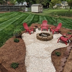 Fire Pit. new bushes, and white rock.