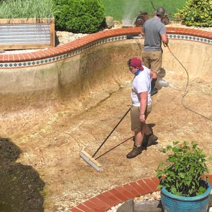 brushing down the sludge to be removed
