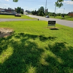 Sign in front of the store near the road