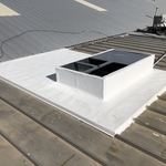 TPO curb flashing on a metal roof.