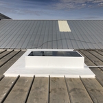TPO curb flashing on a metal roof.