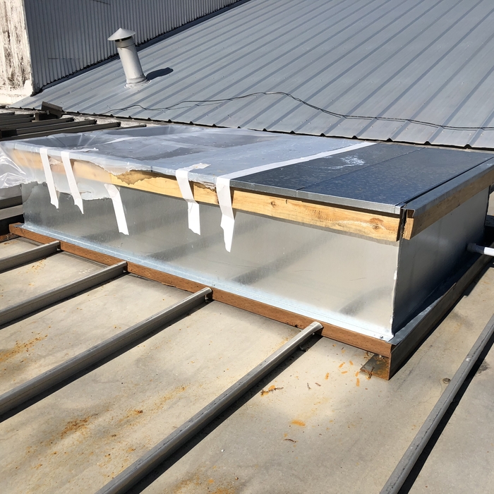 TPO curb flashing on a metal roof