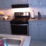 Parallel countertops, stove, & hood.