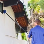 Technician removing webs during a service call