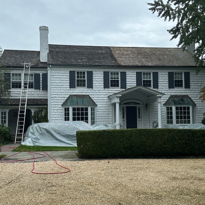 Softwashing a cedar roof to remove moss