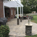 Paver patio, pergola, stone bench, fireplace.