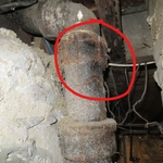Cracked cast iron waste pipe