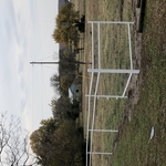 Two rail pipe fence with barbed wire