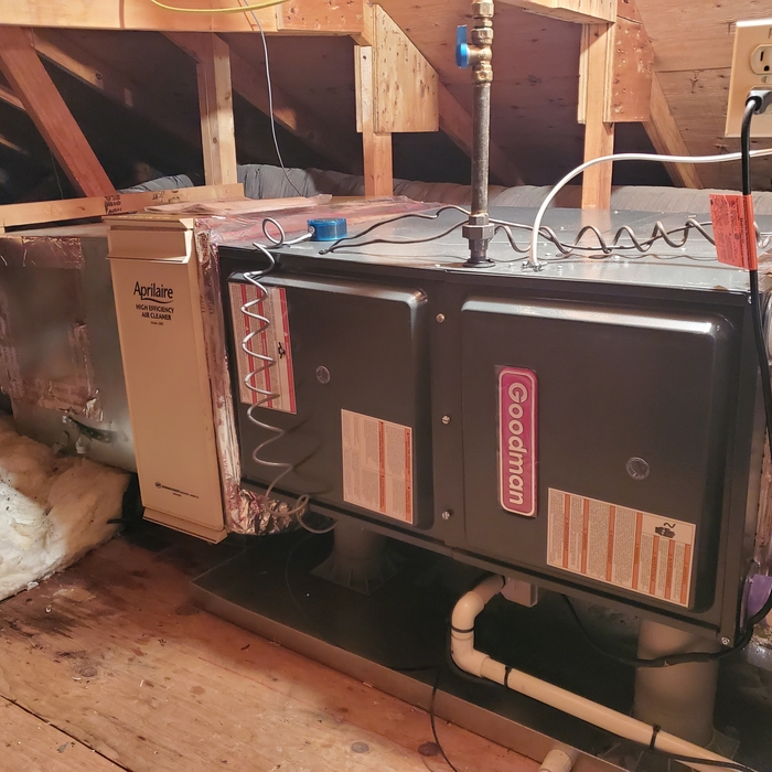 New furnace with heat tape on drain in Attic