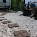 Stepping stones to patio table and gas fireplace