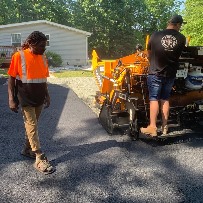 Machine laying hot asphalt